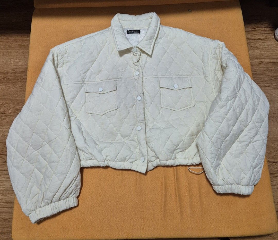 Plus Size Cropped Jacket Shein (Category: Coats, Jackets and Outerwear) located in Manila. Submitted by sorayabarr50152 (Listing ID 1460847221, Image 2). Description: - Cream colored quilted jacket - Features a collar and button-up front - Two chest pockets with button closures - Cropped length - Elasticated cuffs and hem - Cozy and stylish design, ideal for layering.