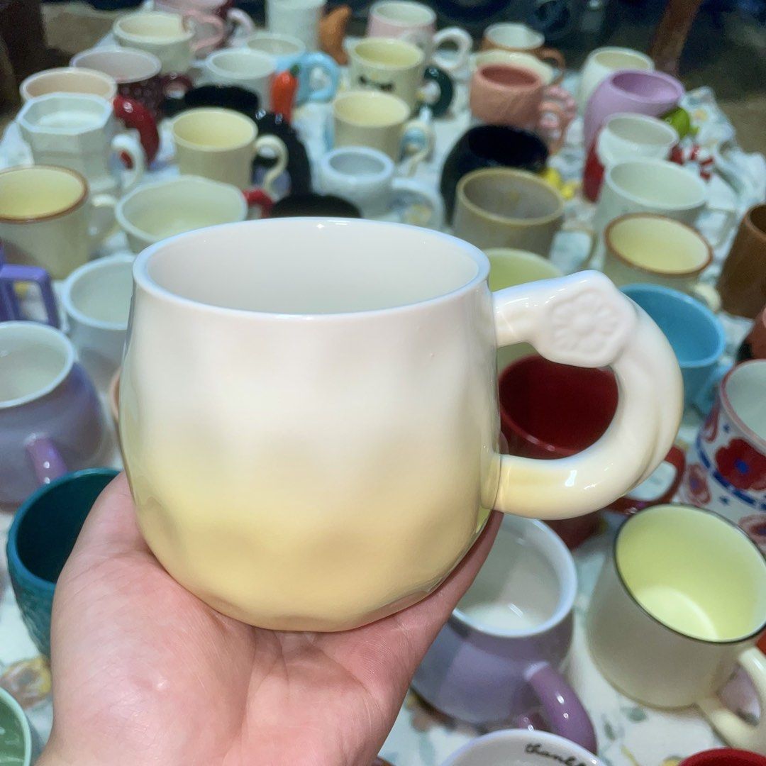 Cute Ceramic Mug with Unique Handle (Category: Coffee & Tea Tableware) located in Valenzuela. Submitted by baekhyunie_pau (Listing ID 1460803800, Image 1). Description: Chunky ceramic mug with a unique sculpted handle. Gradient off-white to pale yellow glaze. Perfect for coffee or tea. More mugs available in my listings! (3 pieces available).