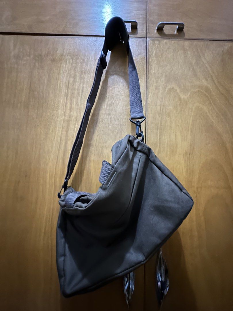 Dark Brown Canvas Messenger Bag with Shoulder Strap (Category: Cross-body Bags) located in Manila. Submitted by silentrabbit_d106dc (Listing ID 1460838307, Image 2). Description: - Very lightweight, good for commute - Versatile dark grey canvas bag - Main zippered compartment - Front zippered pocket - Adjustable shoulder strap - Can be worn as shoulder bag or crossbody.