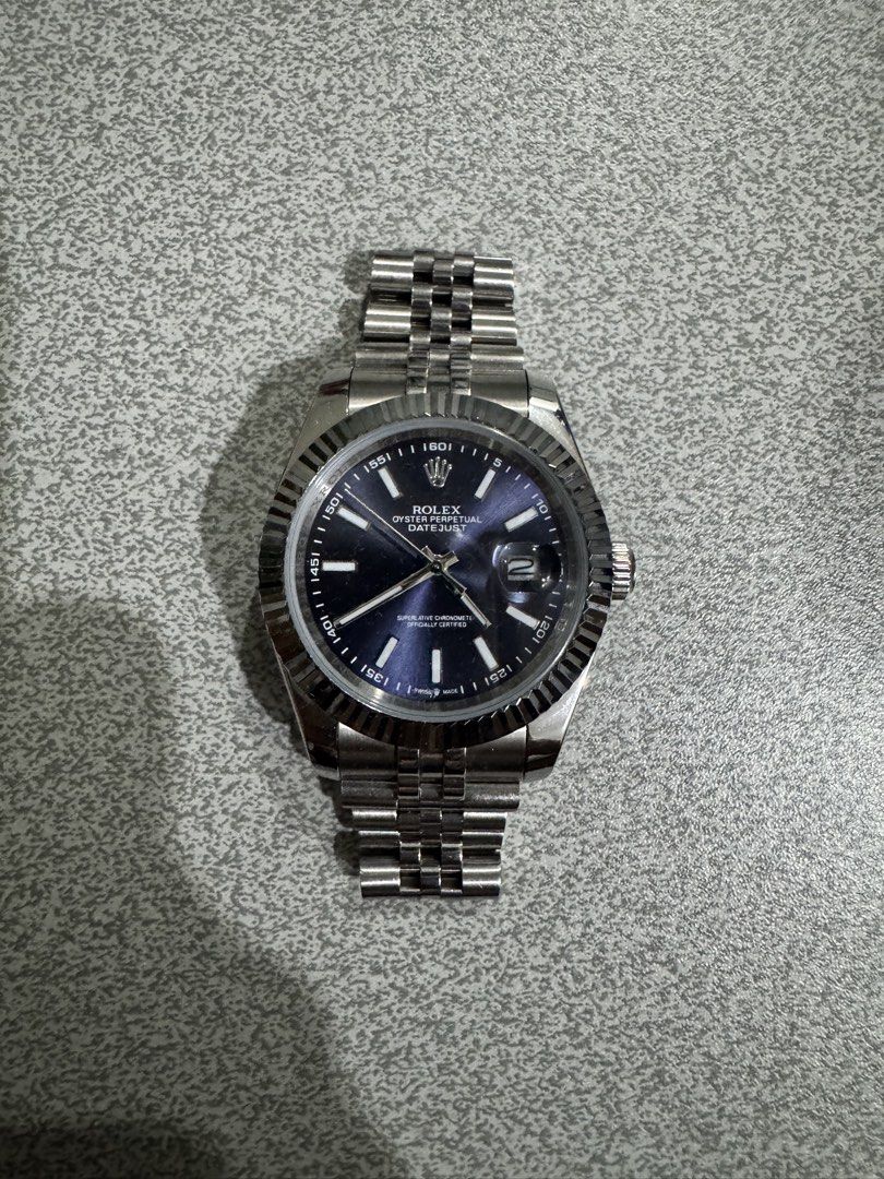 Datejust Style Blue Dial Watch (Category: Women's Watches) located in Manila. Submitted by stefanotolentino (Listing ID 1460853057, Image 1). Description: Selling a Rolex Datejust style watch featuring a sunburst blue dial, fluted bezel, and classic Jubilee-style bracelet. Excellent budget piece for fashion/styling or daily wear. Details & Features: Design: Datejust Dial: Sunburst Blue Dial with baton indices and date window (magnified cyclops le