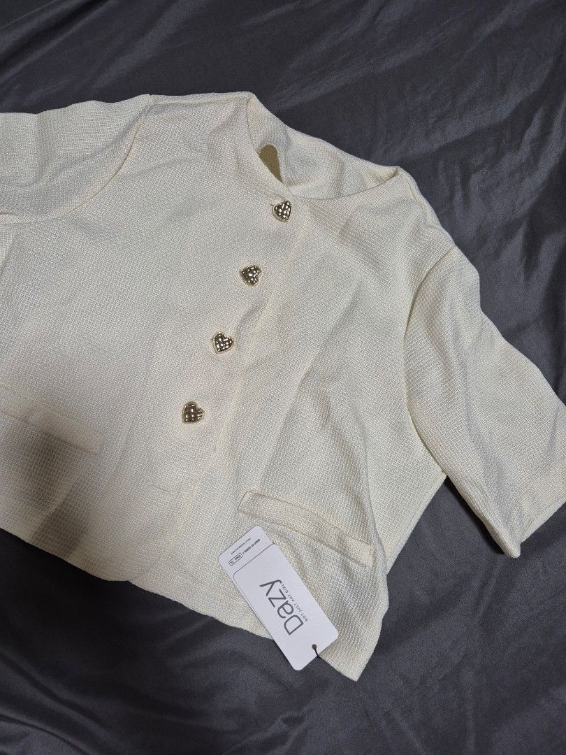 DAZY Cream Textured Jacket with Heart Buttons (Category: Coats, Jackets and Outerwear) located in Santo Tomas. Submitted by bellaswann18 (Listing ID 1460831521, Image 2). Description: - Cream-colored jacket from DAZY - Textured fabric - Cute heart-shaped buttons down the front - 3/4 sleeves - Ideal for layering.