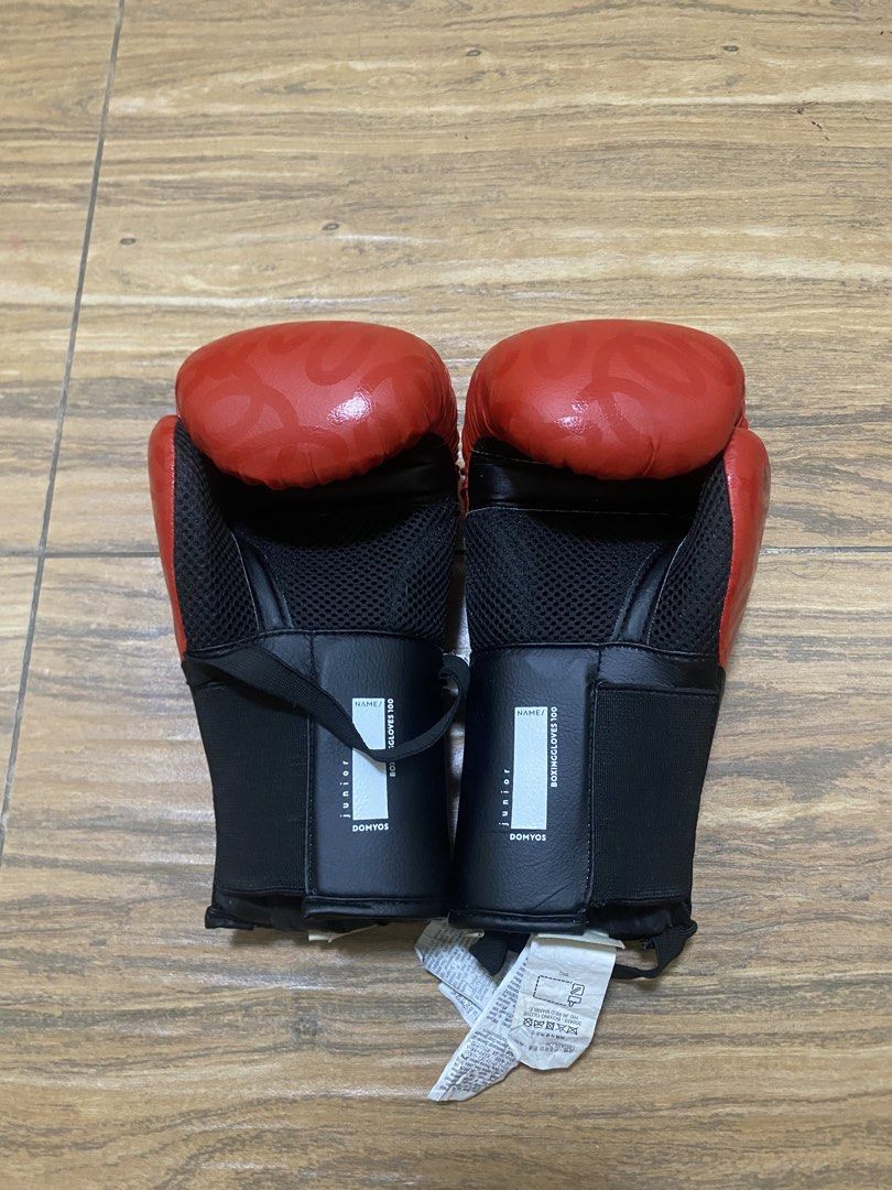 Decathlon Junior Boxing Gloves 6 oz Red (Category: Combat Sports) located in Calamba. Submitted by declutter187 (Listing ID 1460740652, Image 2). Description: - DOMYOS Junior Boxing Gloves - Color: Red - Size: 6 oz - Ideal for training and sparring - Secure velcro strap closure - Breathable mesh lining RFS: Not using, decluttering.