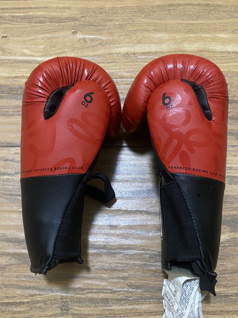 Decathlon Junior Boxing Gloves 6 oz Red (Category: Combat Sports) located in Calamba. Submitted by declutter187 (Listing ID 1460740652, Image 3). Description: - DOMYOS Junior Boxing Gloves - Color: Red - Size: 6 oz - Ideal for training and sparring - Secure velcro strap closure - Breathable mesh lining RFS: Not using, decluttering.