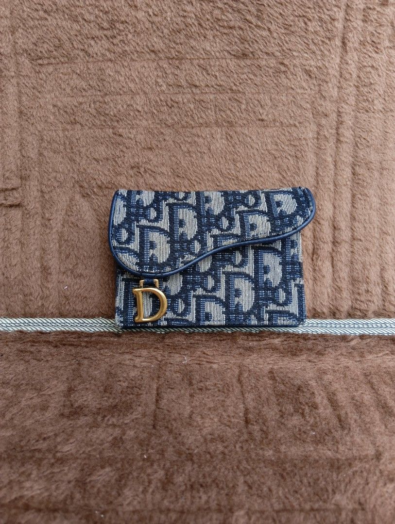 DIOR SADDLE CARD HOLDER (Category: Wallets & Card holders) located in Cagayan de Oro. Submitted by warmbird-f84aab (Listing ID 1460720289, Image 1). Description: • Brand: Christian Dior • Style: Saddle Flap Compact Card Holder • Color: Navy Blue Oblique Jacquard • Code: 43-MA-0173 • Material: Dior Oblique jacquard / Navy smooth calfskin • Serial / Date code: 43-MA-0173 • Includes: Item only 📝 Condition: Pre-loved / Good used condition - Minor ed