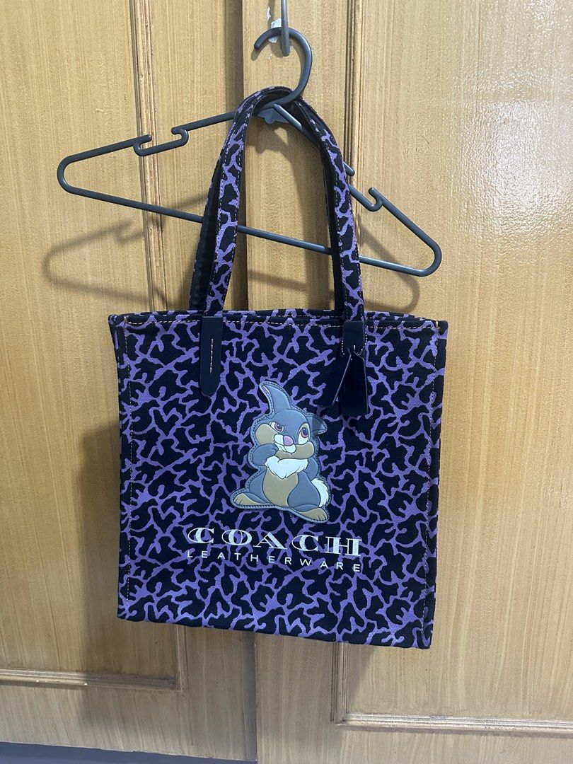 Disney X Coach Totw (Category: Tote Bags) located in Paranaque City. Submitted by shopnichoppy (Listing ID 1460740856, Image 3). Description: This is a purple Disney x Coach Thumper tote bag featuring a graphic patch of Thumper from Bambi on a patterned canvas body..