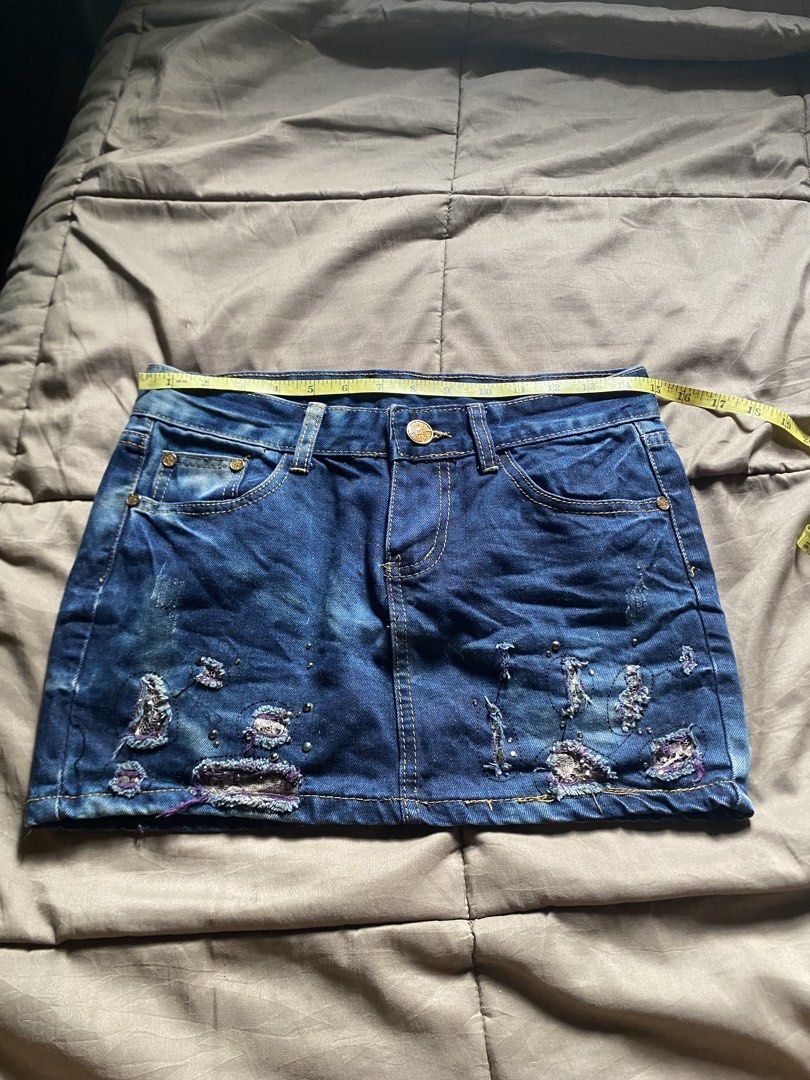 Distressed Denim Mini Skirt with Studs (Category: Skirts) located in Caloocan City. Submitted by lienzonius (Listing ID 1460727467, Image 1). Description: - Dark wash denim mini skirt - Distressed details with purple accents - Stud embellishments - Classic five-pocket styling - Button and zip closure - Approx. 14 inches length - Approx. 28 inches waist - Perfect for an edgy, casual look.