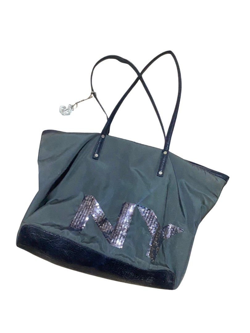 DKNY Sequin Logo Tote Bag (Category: Tote Bags) located in Navotas City. Submitted by sophiadnse (Listing ID 1460792508, Image 2). Description: - DKNY tote bag - Dark Gray with black trim - Eye-catching sequin logo - Spacious interior - Interior zip pockets for organization - Secure main zip closure - Includes a decorative charm on the strap - Ideal for everyday errands or travel adventures.