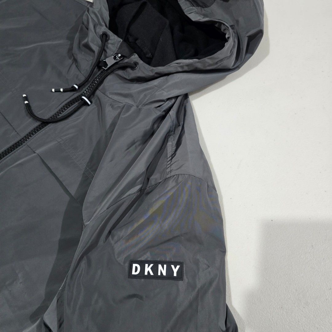 DKNY Sport Windbreaker Jacket Grey Size L (Category: Coats, Jackets and Outerwear) located in Manila. Submitted by nnthrift_ (Listing ID 1460892318, Image 2). Description: - Grey DKNY Sport windbreaker jacket - Size: Large (L) - Features a hood - Equipped with zip pockets - Adjustable drawstring at the hem - Ideal for casual wear or light outdoor activities.