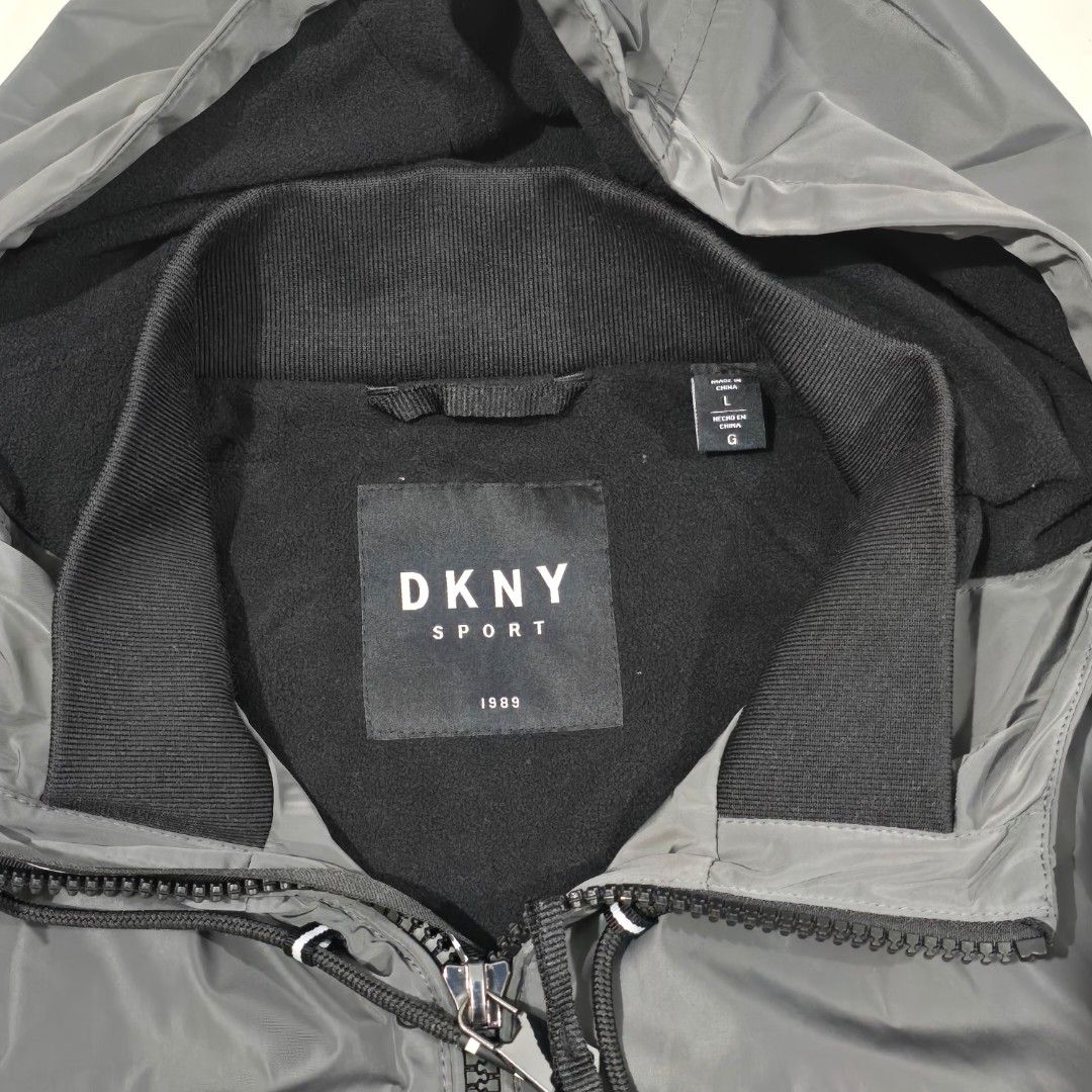 DKNY Sport Windbreaker Jacket Grey Size L (Category: Coats, Jackets and Outerwear) located in Manila. Submitted by nnthrift_ (Listing ID 1460892318, Image 3). Description: - Grey DKNY Sport windbreaker jacket - Size: Large (L) - Features a hood - Equipped with zip pockets - Adjustable drawstring at the hem - Ideal for casual wear or light outdoor activities.