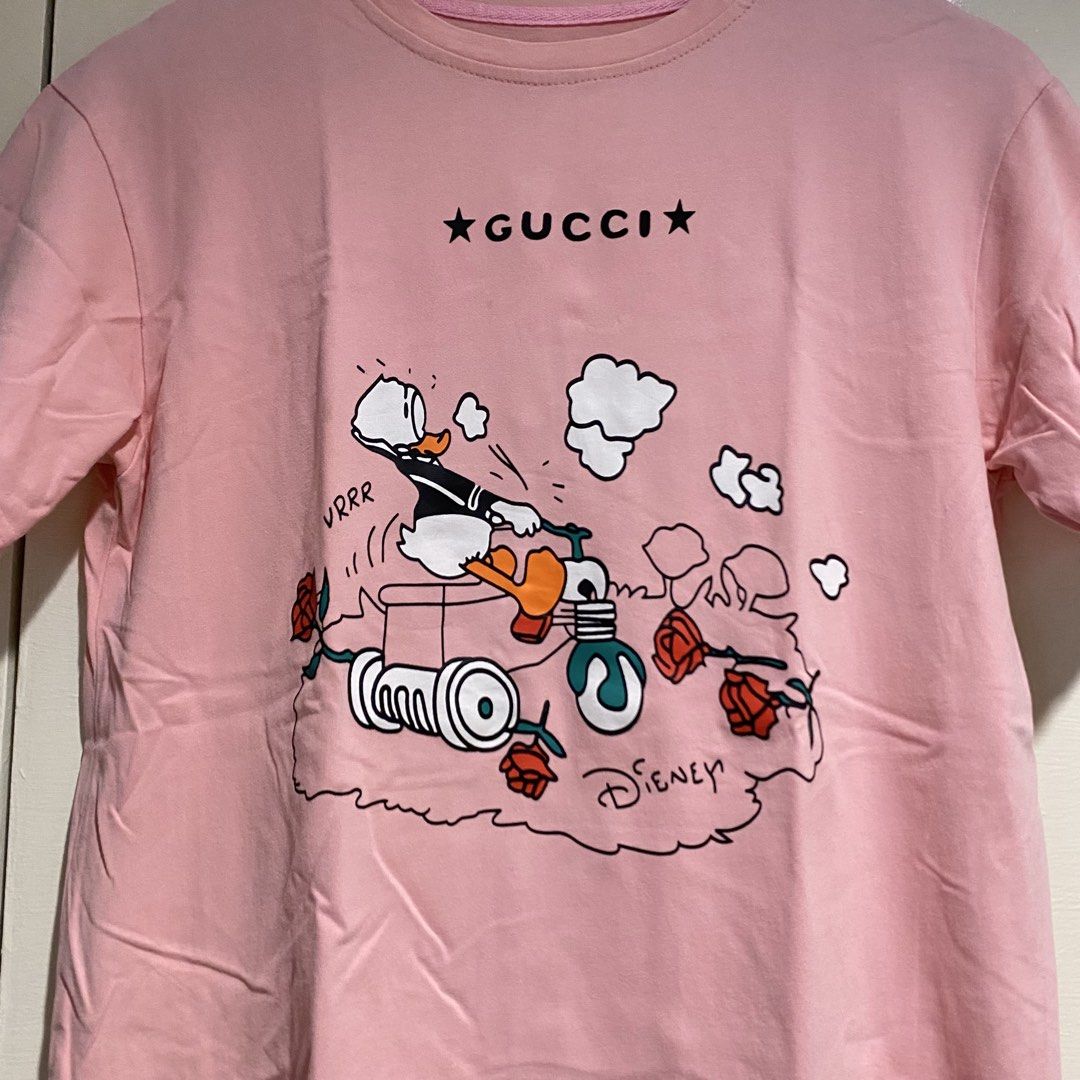Donald duck pink shirt (Category: Shirts) located in Cavite. Submitted by branchee_chic (Listing ID 1460825388, Image 2). Description: M-L May minimals stain pls see photos 🌸A LITTLE NOTE FROM BRANCHEE CHIC🌸 All items are preloved / secondhand and freshly washed, so please manage your expectations. Minor signs of wear or minimal washable stains may be present. Colors may slightly vary from photos due to lighting and screen settings. Please chec