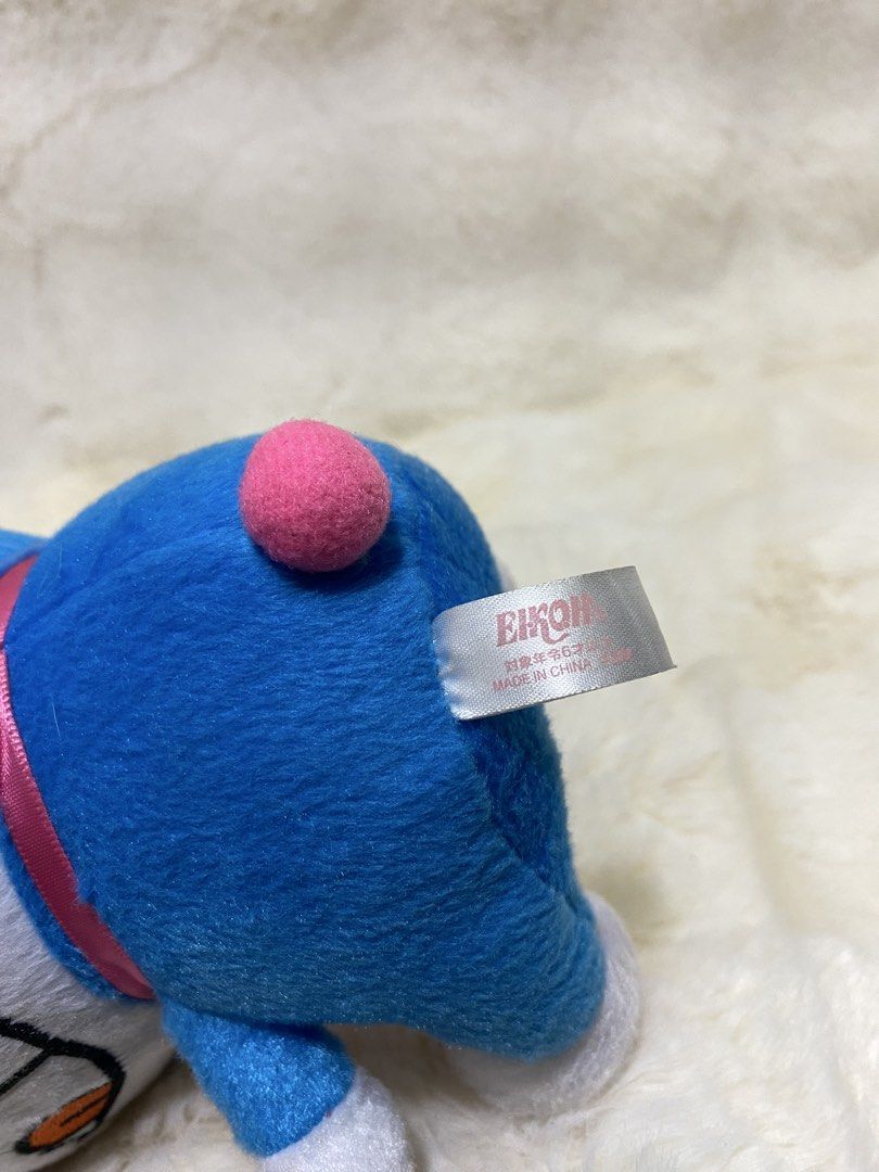 Doraemon x Sanrio Plush (Category: Plushies & Soft Toys) located in Kalibo. Submitted by ollie_stuffshop (Listing ID 1460913150, Image 3). Description: 16cm x 13cm Before you send your inquiries: ❗️Last Price is already posted ❗️Manage your expectations, WYSIWYG ❗️May need washing ❗️Dropoff is every Wednesday & Sunday - Adorable Doraemon plush toy - Features a cute pink bow and pink pom-pom - Approximately 6 inches tall - Made in China - Ideal fo