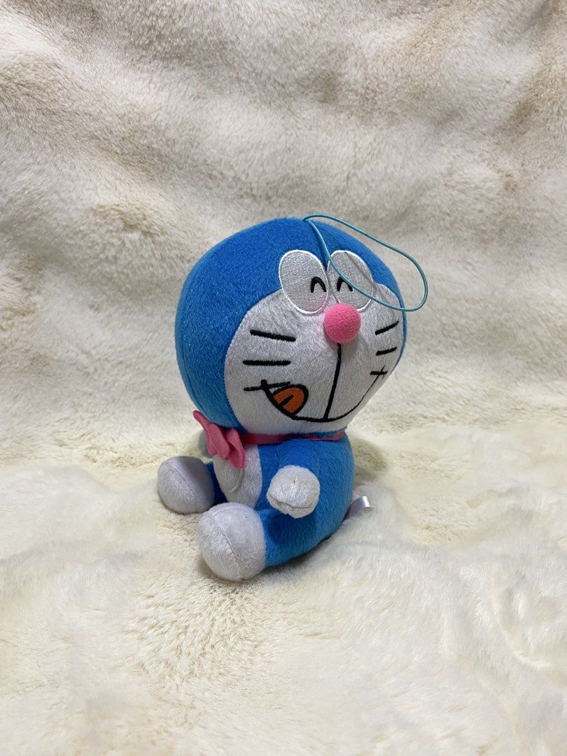 Doraemon x Sanrio Plush (Category: Plushies & Soft Toys) located in Kalibo. Submitted by ollie_stuffshop (Listing ID 1460913150, Image 1). Description: 16cm x 13cm Before you send your inquiries: ❗️Last Price is already posted ❗️Manage your expectations, WYSIWYG ❗️May need washing ❗️Dropoff is every Wednesday & Sunday - Adorable Doraemon plush toy - Features a cute pink bow and pink pom-pom - Approximately 6 inches tall - Made in China - Ideal fo