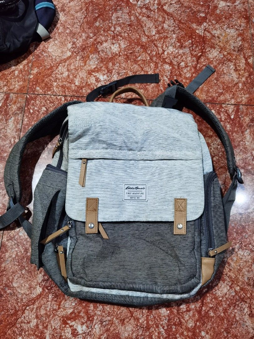 Eddie Bauer First Adventure Backpack (Category: Backpacks) located in Caloocan City. Submitted by cooldudeszion (Listing ID 1460886280, Image 1). Description: - Eddie Bauer backpack in grey and light grey. - Multiple compartments inside, including a zippered pocket. - Insulated front pocket for keeping items cool. - Ideal for day trips, school, or everyday use. - Minor signs of wear on the exterior. Adventure Bag Large capacity More compartment g
