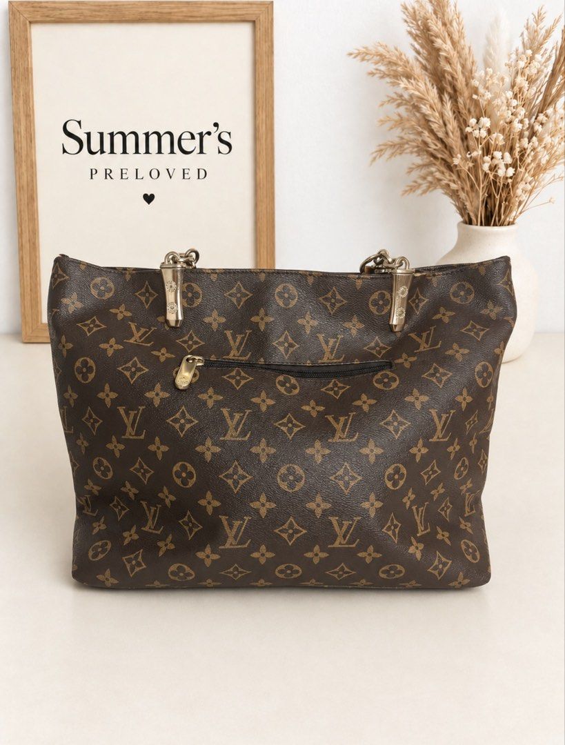 Elvira Monogram Pallas tote (Category: Tote Bags) located in Taguig. Submitted by summers.preloved (Listing ID 1460892589, Image 3). Description: BAG DETAILS 👜 Model: Pallas Tote 🤎 Color: Classic Brown Monogram with Tan Trim ✨ Hardware: Gold-tone metal with chain-link handle attachments 🔒 Closure: Full top-zip closure 👝 Exterior: Rear zip pocket 🧳 Interior: Spacious main compartment with multiple organizer pockets and an interior zip pocket 