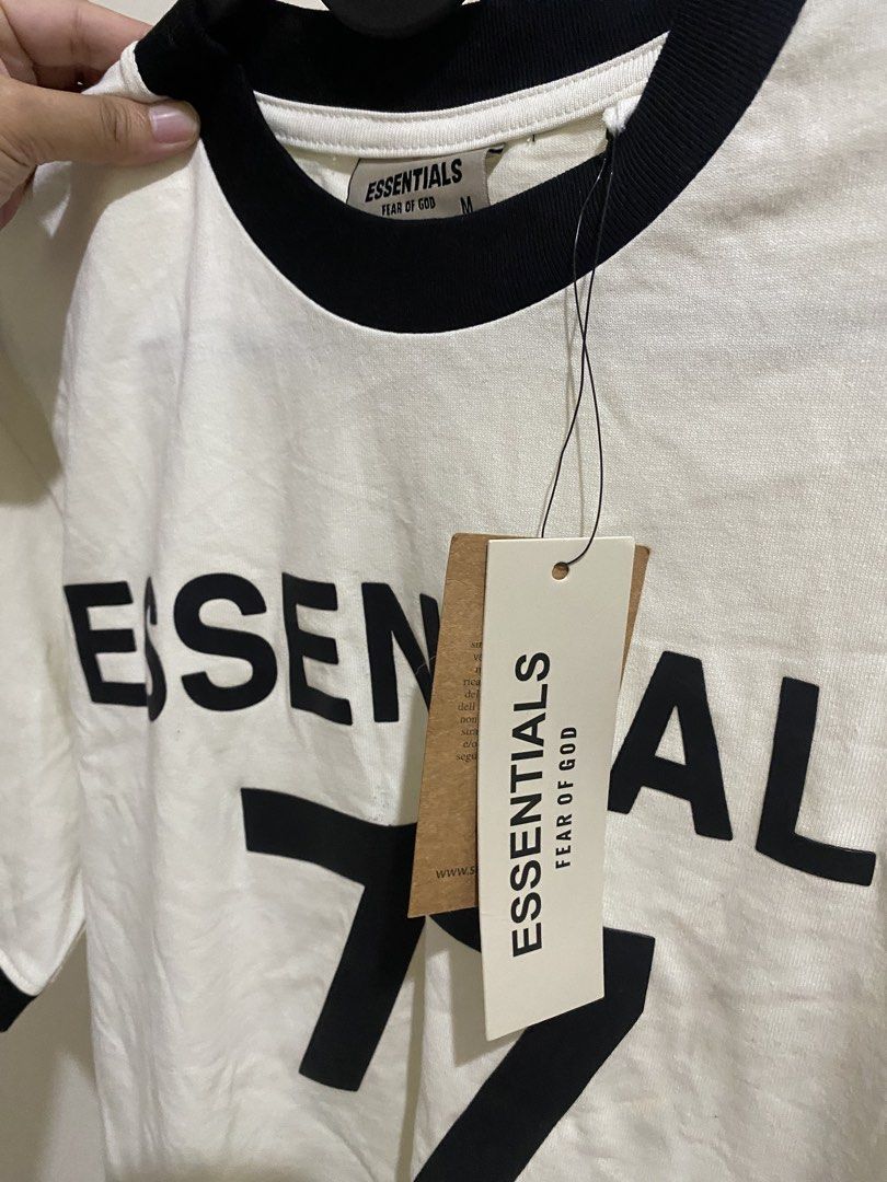 Fear of God Essentials 77 Ringer Tee (Category: Tshirts & Polo Shirts ) located in Pasig City. Submitted by k0pimonster (Listing ID 1460864151, Image 2). Description: - Cream Fear of God Essentials ringer tee - Black trim and '77' graphic on front - Size: Medium (20” x 27”) - Brand new with original tags - Minor marks on fabric (please check photos).