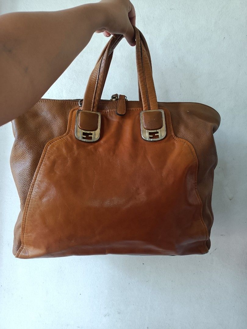 Fendi Leather Tote Bag (Category: Luxury Bags & Wallets) located in Bolinao. Submitted by shayne_0215 (Listing ID 1460732276, Image 1). Description: - Vintage Fendi brown leather tote bag. - Classic design with signature Fendi logo hardware. - Spacious interior, ideal for everyday essentials. - Secure top zipper closure. - Protective metal studs on the bottom. - Beautiful patina adds character to the leather. - A stylish and practical choice for 
