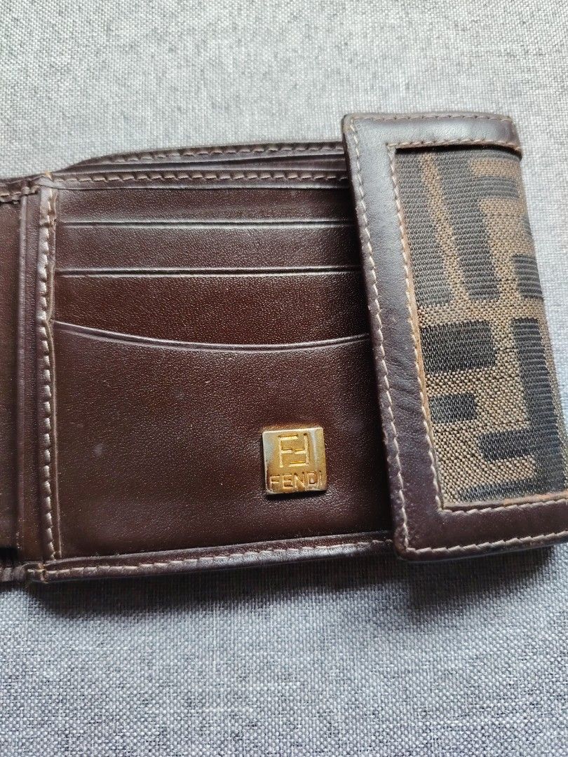 Fendi Zucca Canvas Bifold Wallet (Category: Luxury Bags & Wallets) located in Taguig. Submitted by _theroom.ph (Listing ID 1460767521, Image 3). Description: - Authentic Fendi wallet - Classic Zucca canvas pattern - Brown leather interior - Multiple card slots - Clear ID window - Small Fendi logo detail inside - Folds neatly for easy carrying - Ideal for everyday use Fendi Zucca Canvas Bifold Wallet Rank B 1250 + Shipping Fee Taguig City Loc.
