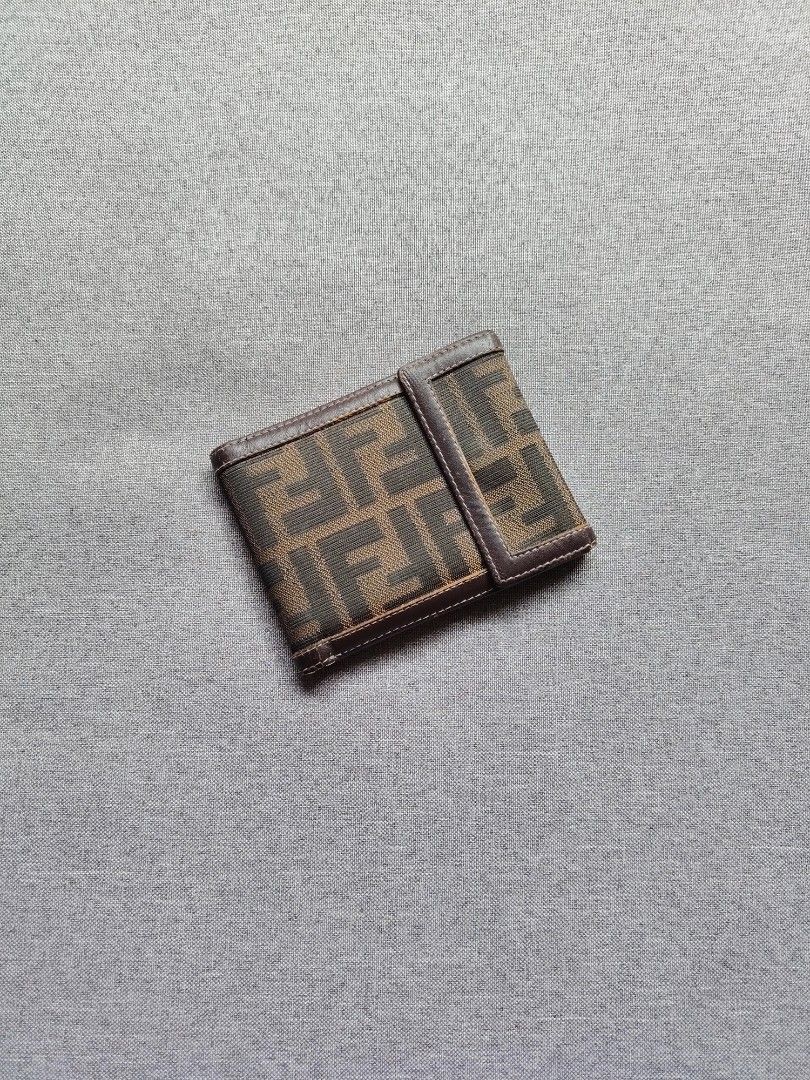 Fendi Zucca Canvas Bifold Wallet (Category: Luxury Bags & Wallets) located in Taguig. Submitted by _theroom.ph (Listing ID 1460767521, Image 1). Description: - Authentic Fendi wallet - Classic Zucca canvas pattern - Brown leather interior - Multiple card slots - Clear ID window - Small Fendi logo detail inside - Folds neatly for easy carrying - Ideal for everyday use Fendi Zucca Canvas Bifold Wallet Rank B 1250 + Shipping Fee Taguig City Loc.