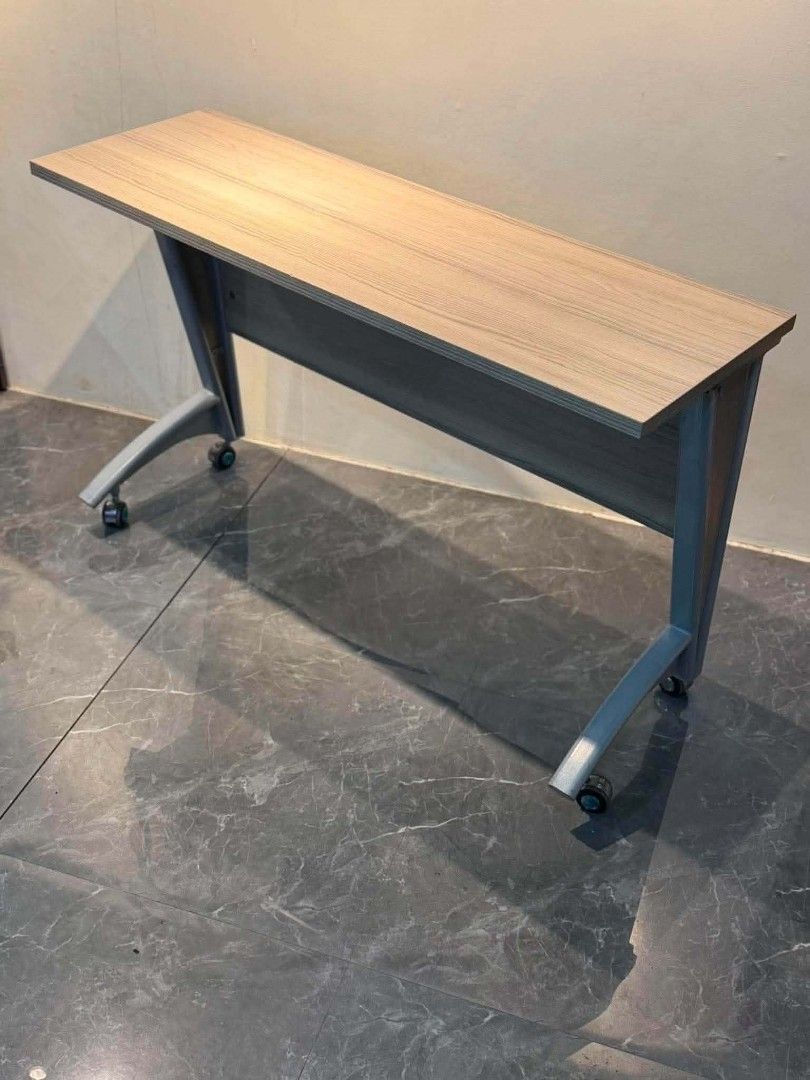 Folding Table with Wheels (Category: Tables & Sets) located in Manila. Submitted by Persephone13 (Listing ID 1460766046, Image 3). Description: - Foldable table with light wood grain top - Sturdy grey metal legs - Equipped with wheels for smooth rolling - Ideal for events, parties, or extra workspace - Folds down compactly for easy storage.