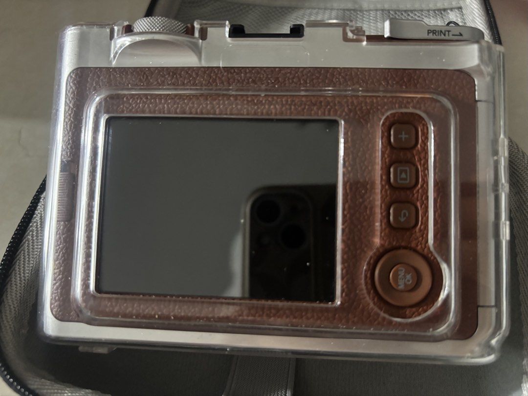 Fujifilm Instax Mini Evo (Brown) (Category: Cameras) located in Manila. Submitted by ljb1234 (Listing ID 1460727950, Image 2). Description: - Fujifilm Instax Mini Evo - Stylish brown leather-look finish - Comes with a clear protective case, hard case, and lace - 28mm f/2.0 lens for great shots - Focus range: 0.1m to infinity - Built-in print function - Rear screen for easy viewing and settings - Capture and print your memories instantly!.