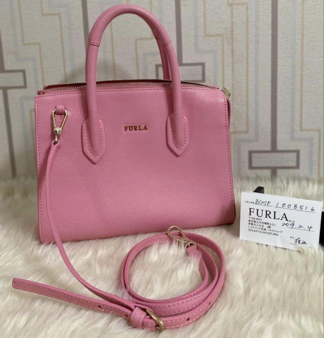 Furla Pink Leather Top Handle Bag with Strap (Category: Luxury Bags & Wallets) located in Marilao. Submitted by vhi3yhn (Listing ID 1460766326, Image 1). Description: - Original Pink Furla Handbag - Textured Leather Material - Versatile: Top Handles & Detachable Shoulder Strap - Secure Zip Closure - Organized Interior: Zip Pocket & Slip Pockets - Elegant Gold Hardware - Comes with Authenticity Card.