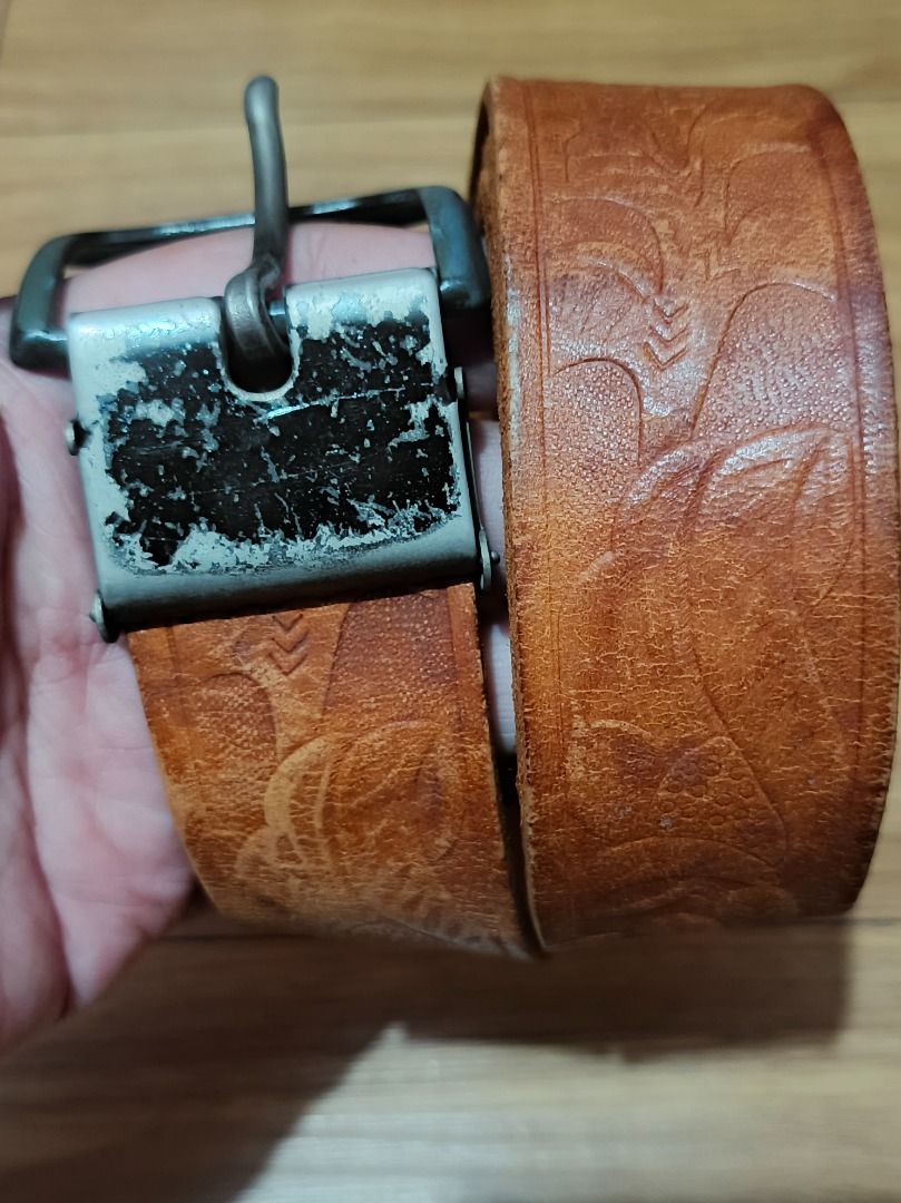 Genuine Belt with Embossed Pattern (Category: Belts) located in Makati City. Submitted by nyxhemera26 (Listing ID 1460800088, Image 2). Description: Genuine Belt with Embossed Pattern - Vintage condition with visible signs of usage - Please note that belt loop is missing - Stylish brown leather belt with an all-over embossed pattern. - Features a metal buckle with slight signs of wear. - Nice tan leather color. - 41.5 inches end to end - Perfect 