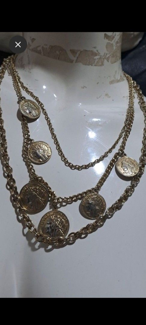 Gold Tone Multi-Layered Coin Necklace (Category: Necklaces) located in Davao. Submitted by bravemoon_556cd5 (Listing ID 1460867874, Image 1). Description: - Gold-tone layered necklace - Multiple chains of varying lengths - Coin-shaped pendants with profile and laurel wreath design - Vintage feel - Perfect statement piece.