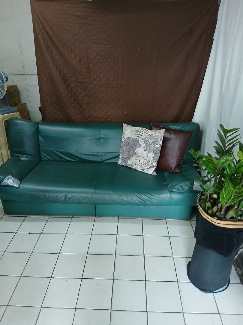 Green Faux Leather Sofa Bed with Storage (Category: Sofas) located in Dasmarinas. Submitted by tataysgarage (Listing ID 1454799362, Image 1). Description: 3-Seater Sofa Bed with 2 storage drawer. Foldable at 3 angles, Need re-upholstery and drawer repairs. Still functional as a sofa and bed. 6 ft long. Great for spare rooms ,garage, basement or student housing. Dasma Cavite Area.