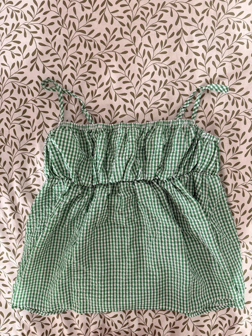 Green Gingham Smocked Cami Top (Category: Sleeveless) located in Manila. Submitted by ynasbr (Listing ID 1460787937, Image 1). Description: - Cute green gingham cami top - Smocked bust for a flattering fit - Empire waist - Adjustable spaghetti straps - Lightweight and flowy fabric - Ideal for summer wear - Versatile: pair with jeans or shorts.