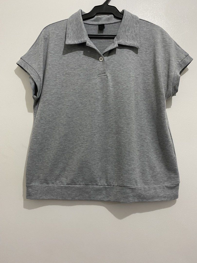 Grey Short Sleeve Polo Shirt (Category: Blouses) located in Pulilan. Submitted by chibimoon81 (Listing ID 1460886206, Image 1). Description: - Grey short sleeve polo shirt - Button closure at the neck - Simple and classic design - Versatile for casual wear or layering - Easy to match with any outfit.