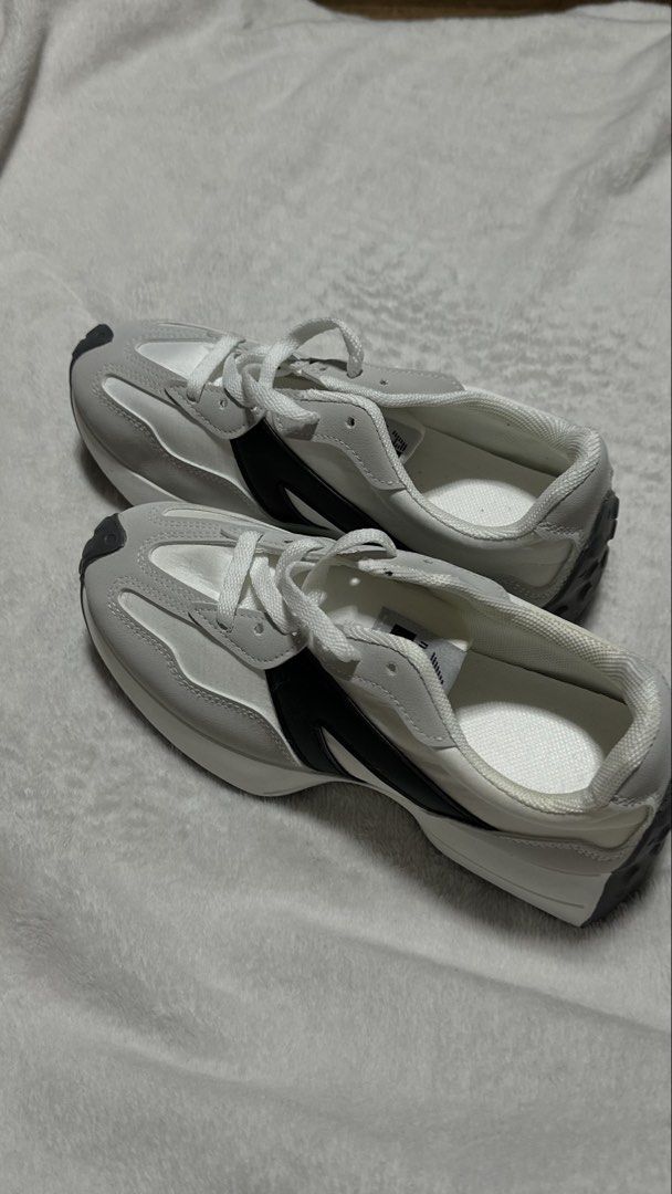 Grey White Black Sneakers (Category: Sneakers) located in Pasig City. Submitted by lunaris3417 (Listing ID 1460817746, Image 1). Description: - Features black accents on the side - Lace-up closure for a secure fit - Comfortable for everyday wear - Ideal for casual outfits - Reason for selling: Does not fit.
