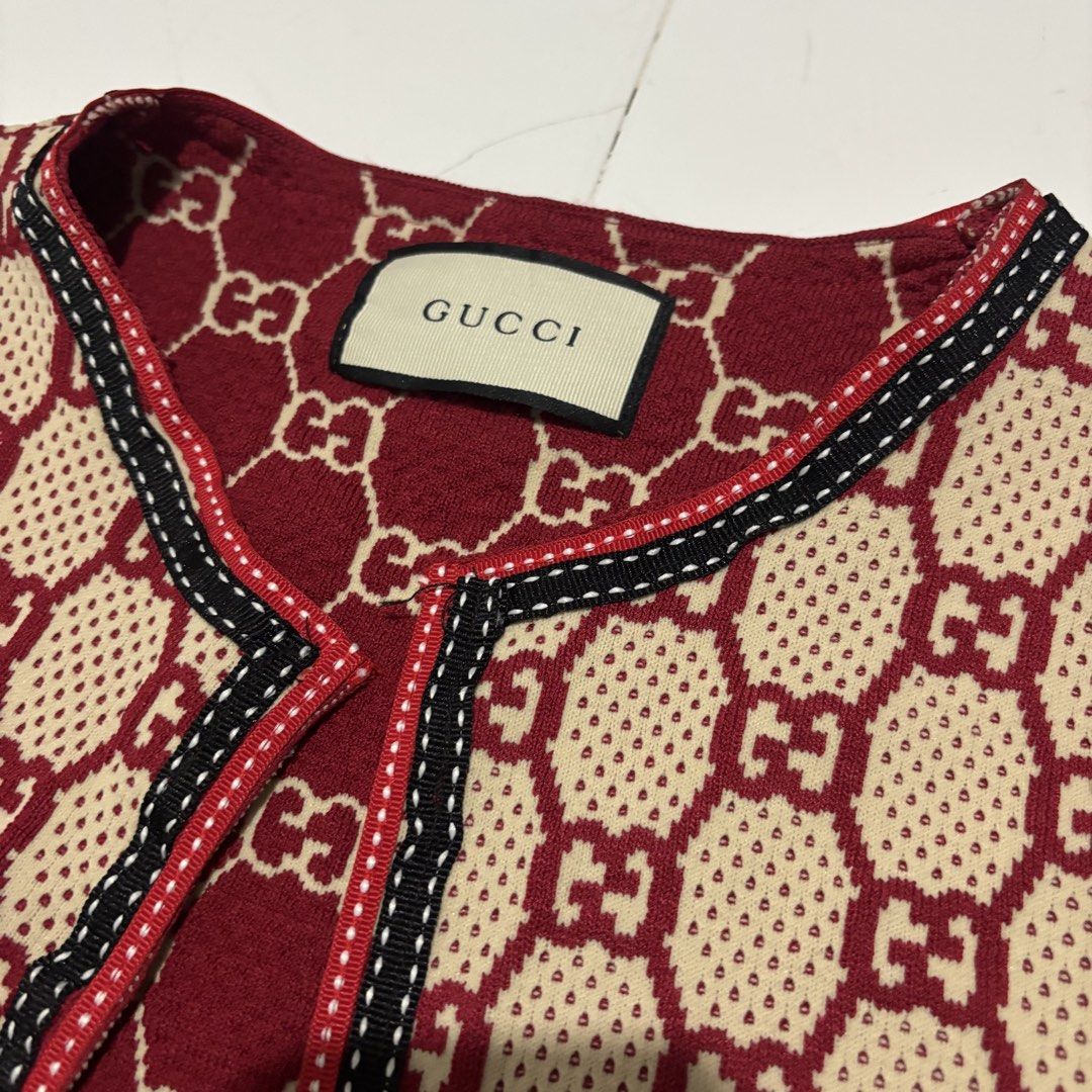 Gucci GG Monogram Knit Cardigan (Category: Luxury Apparel) located in Banga. Submitted by akosiloco (Listing ID 1460723732, Image 2). Description: - Iconic Gucci GG monogram pattern all over - Classic burgundy and beige colorway - Trimmed with red, black, and white ribbon detail - Two functional front pockets - A must-have for any Gucci lover Width 20 Length 29 Excellent Condition 9.8/10 .