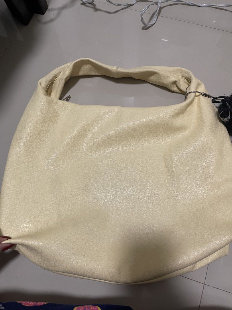 GVN hobo bag in butter (Category: Shoulder Bags) located in Paranaque City. Submitted by graceshanp (Listing ID 1460883330, Image 2). Description: - Cream colored shoulder bag - Made of faux leather - Zipper closure for security - Light-colored fabric lining - Comfortable wide strap - Adorable plush charm included - Ideal for everyday wear LP ALREADY! .