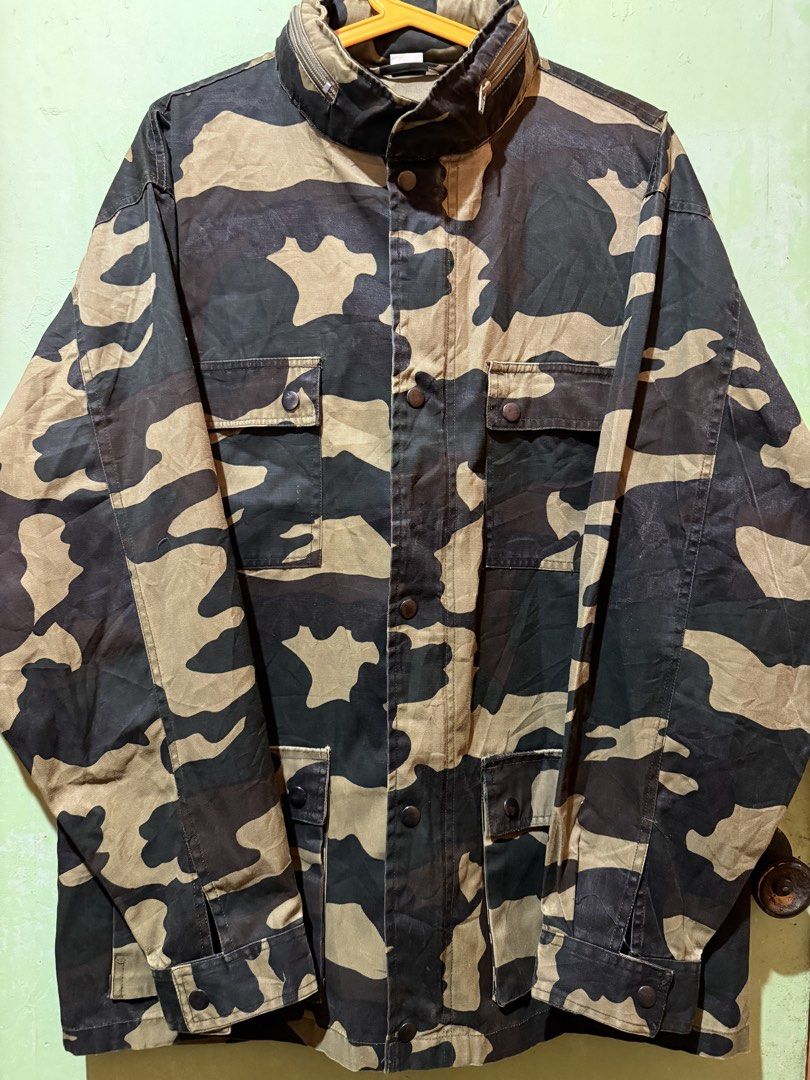 Heavy Camo Utility Field Jacket with Packable Hood (Category: Coats, Jackets and Outerwear) located in Manila. Submitted by reransssssssssssssss.cloud (Listing ID 1460788871, Image 3). Description: Length 30 Width 25 Rugged military fatigue field jacket in a bold French CCE / woodland brushstroke camouflage. Built with a structured cotton-poly twill shell, oversized boxy drape, and utilitarian details including four front snap-cargo pockets, adju