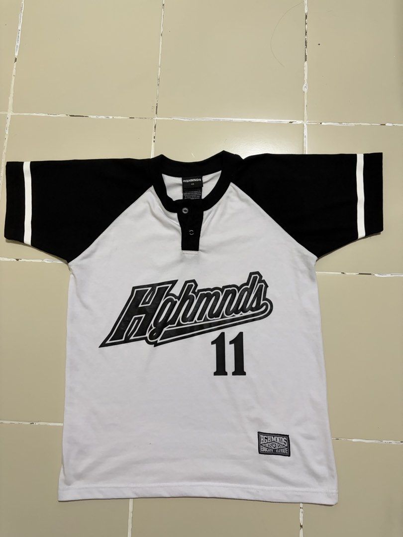 HGHMNDS 11 Baseball T-shirt (Category: Tshirts & Polo Shirts ) located in Manila. Submitted by yurisgn (Listing ID 1460888012, Image 1). Description: - Brand: HGHMNDS - Style: Black and white raglan t-shirt - Design: Features brand name and '11' graphic on front - Details: Two white stripes on sleeves - Closure: Button closure at the neck.