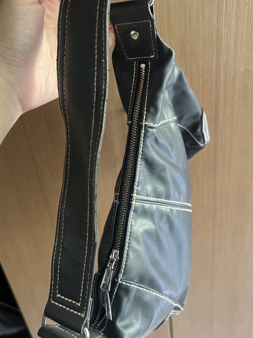 H&M Black Leather Shoulder Bag with Contrast Stitching (Category: Purses & Pouches) located in Manila. Submitted by honey.001 (Listing ID 1460745674, Image 3). Description: * Brand: H&M * Color: Black with white contrast stitching * Style: Trendy Y2K style slouchy shoulder bag / hobo handbag * Material: Smooth leather material * Closure: Top zipper with silver hardware accent * Condition: Great pre-loved condition, well-maintained.