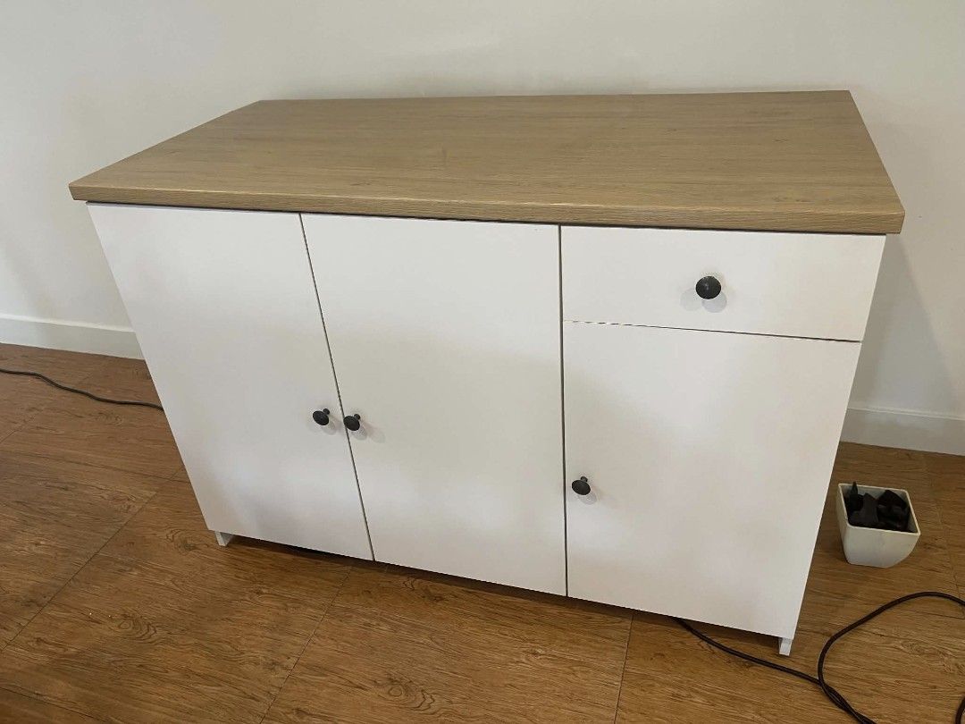 IKEA Modern Home Cabinet (Category: Shelves, Cabinets & Racks) located in Quezon City. Submitted by zwit1492 (Listing ID 1460823534, Image 3). Description: - Modern IKEA cabinet - White body with wood-look top - Features 3 doors and 1 drawer - Stylish black handles - Perfect for home organization.