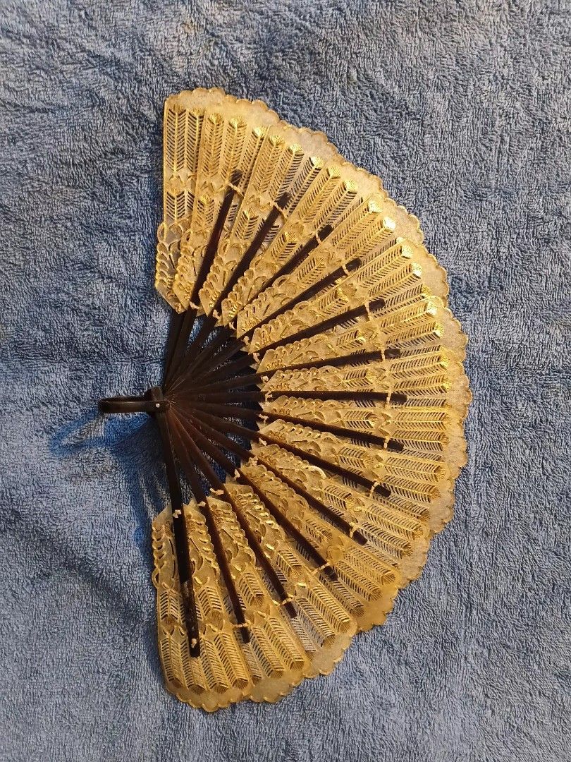 Indonesian Wayang folding hand fan (Category: Fans) located in Manila. Submitted by gt747express (Listing ID 1460892698, Image 2). Description: This object is an antique Javanese Wayang folding fan from Indonesia. It is an openwork, brisé-style fan handcrafted from gilded and pierced animal vellum (parchment), typically made from water buffalo hide. size : 9 x 15 inches spread.