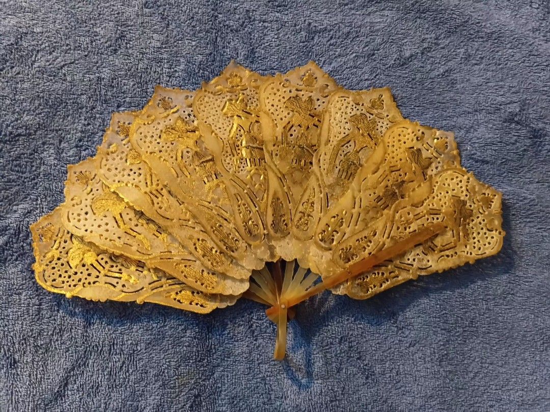 Indonesian Wayang folding hand fan (Category: Fans) located in Manila. Submitted by gt747express (Listing ID 1460893480, Image 1). Description: This object is an antique Javanese Wayang folding fan from Indonesia. It is an openwork, brisé-style fan handcrafted from gilded and pierced animal vellum (parchment), typically made from water buffalo hide. size : 9 x 14 inches spread.