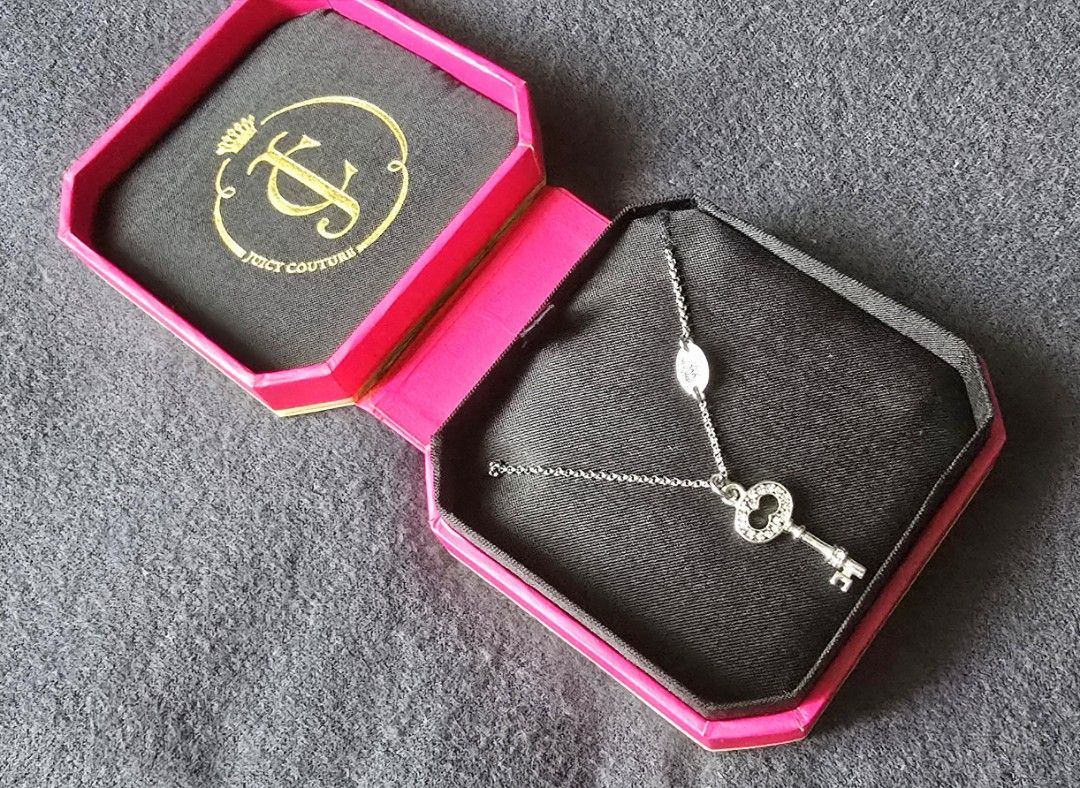 Juicy Couture Key Wish Necklace (Category: Luxury Accessories) located in Pasig City. Submitted by peony_princess (Listing ID 1460742677, Image 1). Description: Authentic Juicy Couture necklace featuring a key pendant with sparkling accents. The necklace comes with its original box and packaging. The sticker price tag on the box indicate 2,650 PHP. The necklace has a silver-tone chain with an adjustable length and a small crown charm near the cla