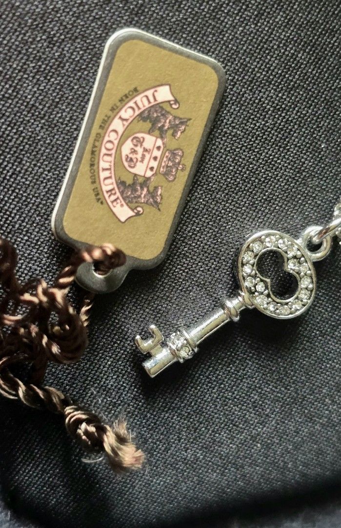 Juicy Couture Key Wish Necklace (Category: Luxury Accessories) located in Pasig City. Submitted by peony_princess (Listing ID 1460742677, Image 3). Description: Authentic Juicy Couture necklace featuring a key pendant with sparkling accents. The necklace comes with its original box and packaging. The sticker price tag on the box indicate 2,650 PHP. The necklace has a silver-tone chain with an adjustable length and a small crown charm near the cla