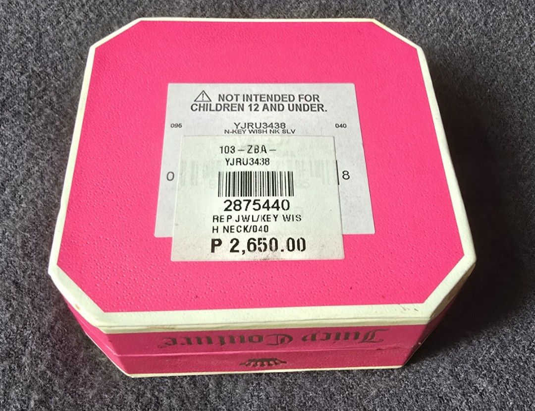 Juicy Couture Key Wish Necklace (Category: Luxury Accessories) located in Pasig City. Submitted by peony_princess (Listing ID 1460742677, Image 2). Description: Authentic Juicy Couture necklace featuring a key pendant with sparkling accents. The necklace comes with its original box and packaging. The sticker price tag on the box indicate 2,650 PHP. The necklace has a silver-tone chain with an adjustable length and a small crown charm near the cla