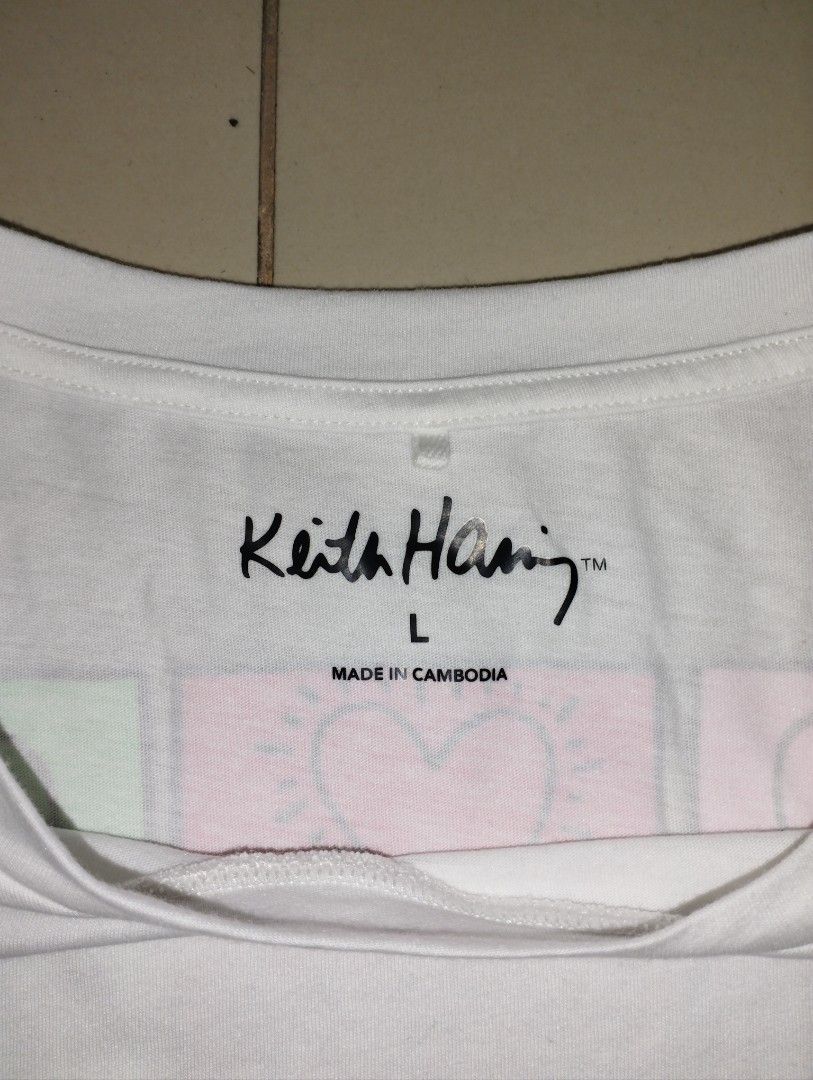 Keith Haring White T-Shirt Size L (Category: Tshirts & Polo Shirts ) located in Manila. Submitted by jmz_thrifted (Listing ID 1460881274, Image 3). Description: - White t-shirt featuring iconic Keith Haring graphics - "Heart Man" graphic on the front left hem - Grid of colorful hearts on the back - Size: Large (L) - Made in Cambodia - Perfect for Keith Haring art enthusiasts No Issue, Need To Wash 📥📥📥.