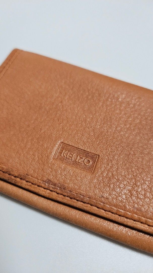 KENZO Brown Leather Bifold Wallet (Category: Luxury Bags & Wallets) located in Alfonso. Submitted by jbcamet (Listing ID 1460828383, Image 2). Description: - Brand: KENZO - Material: Brown Leather - Exterior: Textured with embossed logo - Interior: Card slots - Style: Classic bifold, perfect for everyday use.