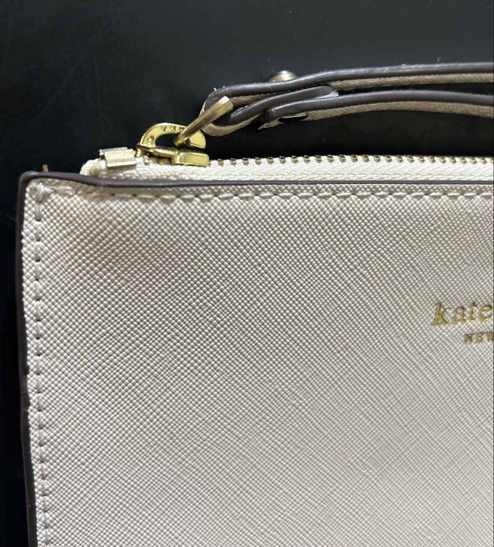 KS pouch (Category: Purses & Pouches) located in Marikina City. Submitted by decluttering.matters (Listing ID 1460808042, Image 2). Description: Given to me as a gift, unused but kept in storage for some time I DO NOT GUARANTEE THE AUTHENTICITY OF THIS ITEM since it was only given to me as a gift. That is why I am selling it for a low price lang. YKK zipper. All rubber linings are intact. No stains. Medyo faded gold na yung spade (not sure kung g