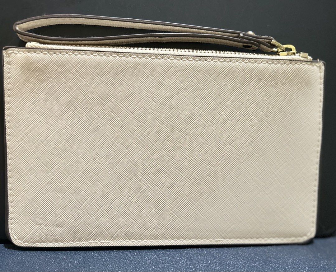KS pouch (Category: Purses & Pouches) located in Marikina City. Submitted by decluttering.matters (Listing ID 1460808042, Image 3). Description: Given to me as a gift, unused but kept in storage for some time I DO NOT GUARANTEE THE AUTHENTICITY OF THIS ITEM since it was only given to me as a gift. That is why I am selling it for a low price lang. YKK zipper. All rubber linings are intact. No stains. Medyo faded gold na yung spade (not sure kung g