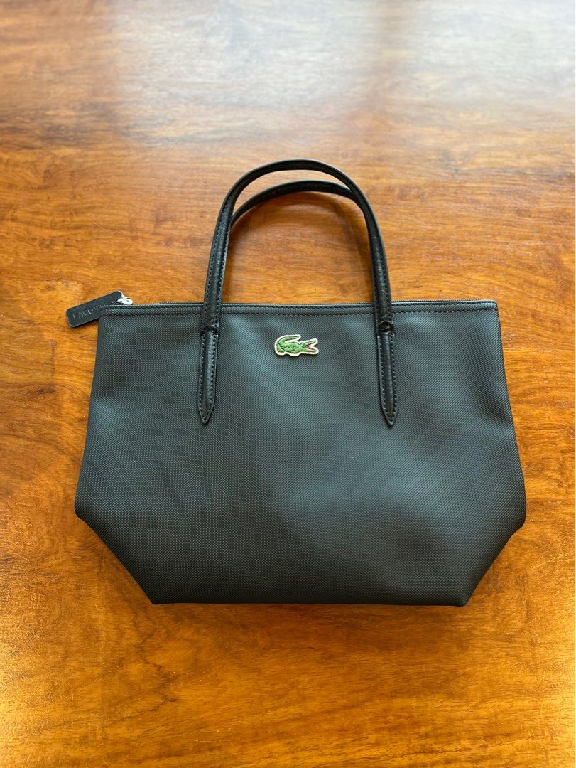 Lacoste Black Tote Bag with Crocodile Logo (Category: Tote Bags) located in Makati City. Submitted by apwellloved (Listing ID 1460779841, Image 1). Description: - Authentic Classic black Lacoste tote bag - Features iconic green crocodile logo - Made with durable material - Genuine leather handles - Secure zip closure - Interior zip pocket for essentials - Stylish and perfect for everyday use.