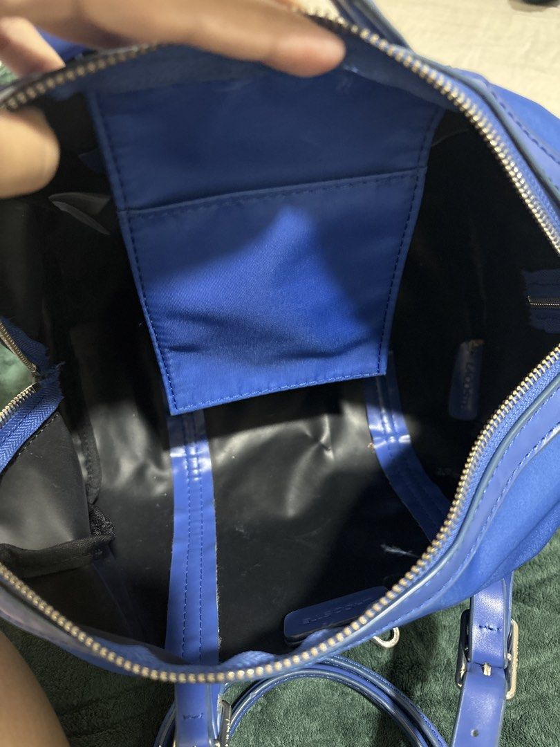 Lacoste Blue Nylon Bag with Shoulder Strap (Category: Shoulder Bags) located in Quezon City. Submitted by chandria123 (Listing ID 1460803796, Image 2). Description: - Cobalt Blue Lacoste small duffle bag - Durable nylon material -Silver hardware - Detachable shoulder strap included - Interior pocket for organization - Ideal size for daily use can store a lot - Minor stain on the side - Small tear on the bottom - Zippers are fully functional -Zipp
