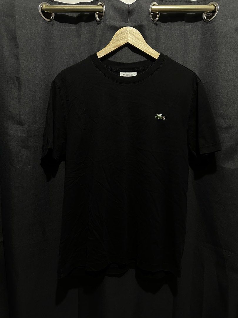 Lacoste Classic Chest Logo Essential Tee (Category: Tshirts & Polo Shirts ) located in Buenavista. Submitted by themodernrack (Listing ID 1460875218, Image 1). Description: Brand: Lacoste Color: Black Style: Casual Essential Crewneck Tee (Features classic embroidered green crocodile logo on left chest) Tag Size: FR 5 / US L (Relaxed Fit) Condition: Good used condition (Minimal collar fade, minor general wash wear) Measurements (Inches): Width (Pi