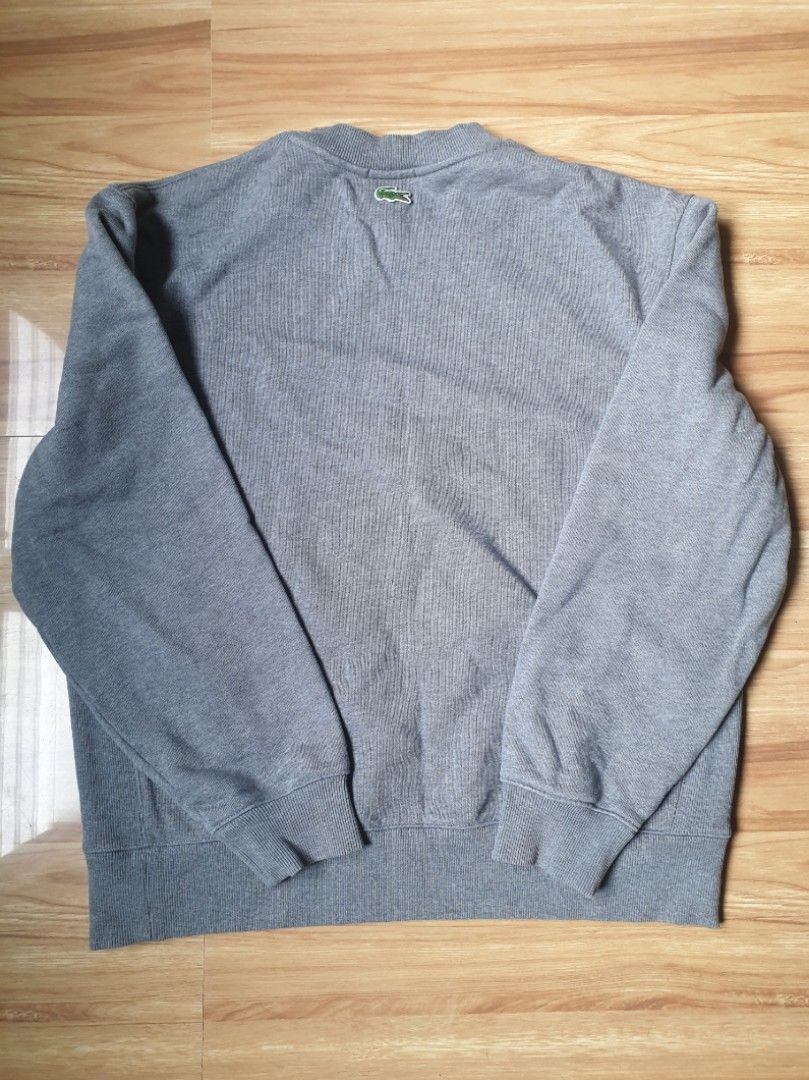 Lacoste gray crewneck sweater original (Category: Coats, Jackets and Outerwear) located in Paranaque City. Submitted by nvdluxurygoods (Listing ID 1460729987, Image 2). Description: unisex for men and womem no issue, no flaws, authentic guaranteed gray to medium dark gray color -ready to ship♡ Lacoste crewneck sweatshirt featuring an oversized circular 3D crocodile logo on the chest Size: L Price: 3,500 (negotiable♡).